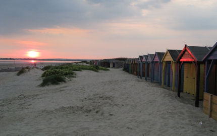 The sun sets over the white sands in West Wittering, West Sussex